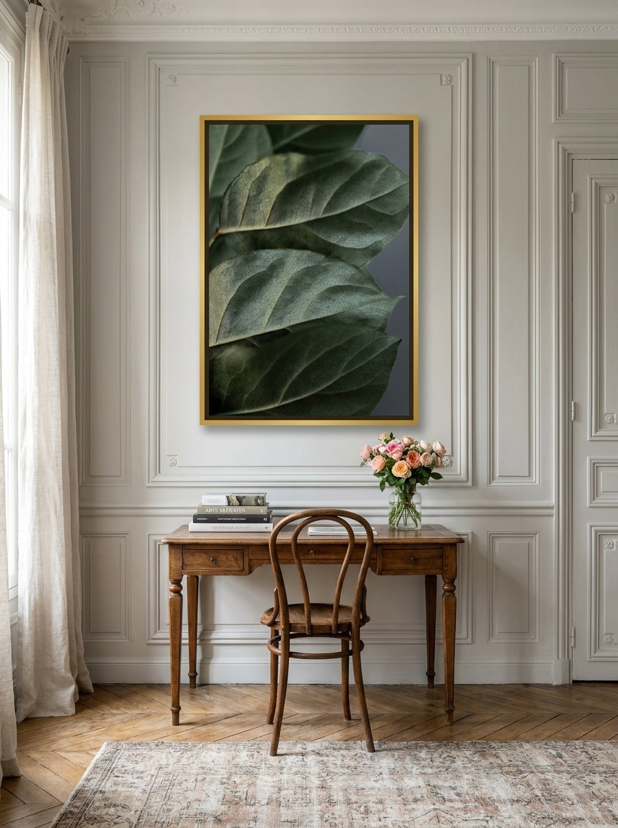 Canvas wall art with a gold leaf surround styled on the wall in a Parisian home office