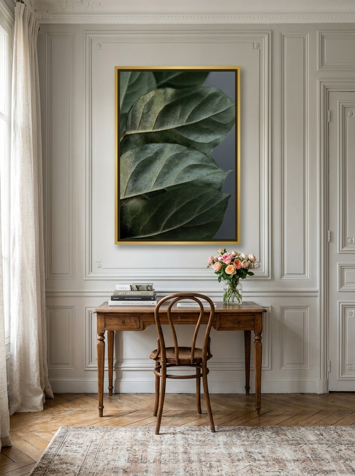 Canvas wall art with a gold leaf surround styled on the wall in a Parisian home office