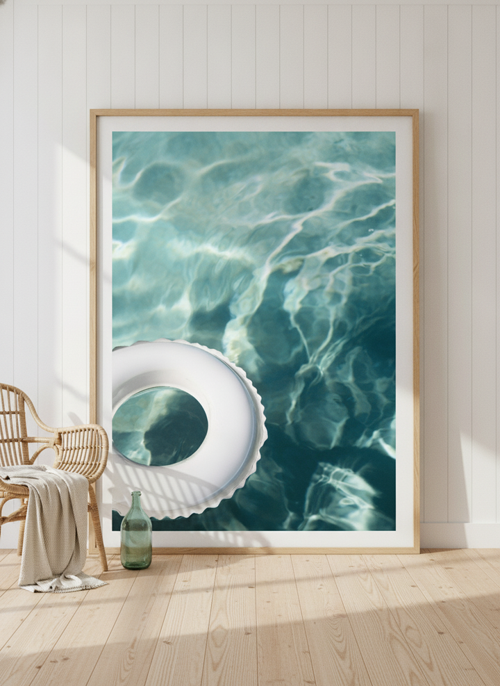 Oversized statement modern wall art print leaning against the wall in a coastal dining room