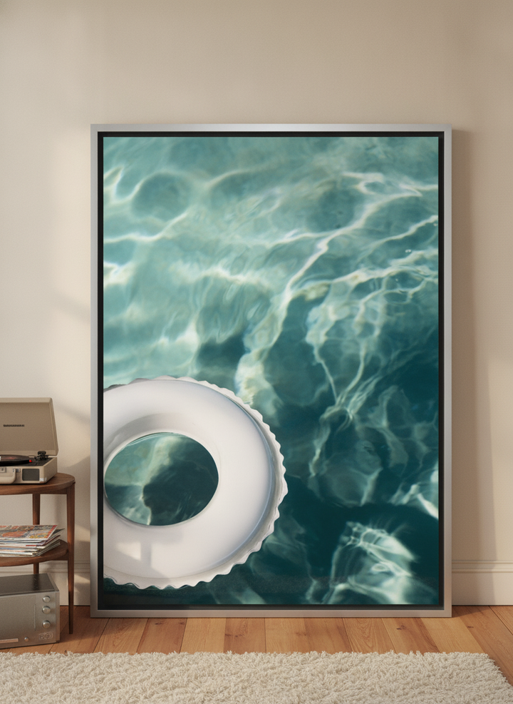 Oversized statement canvas wall art with a silver leaf surround leaning against the wall in a retro 70s living room