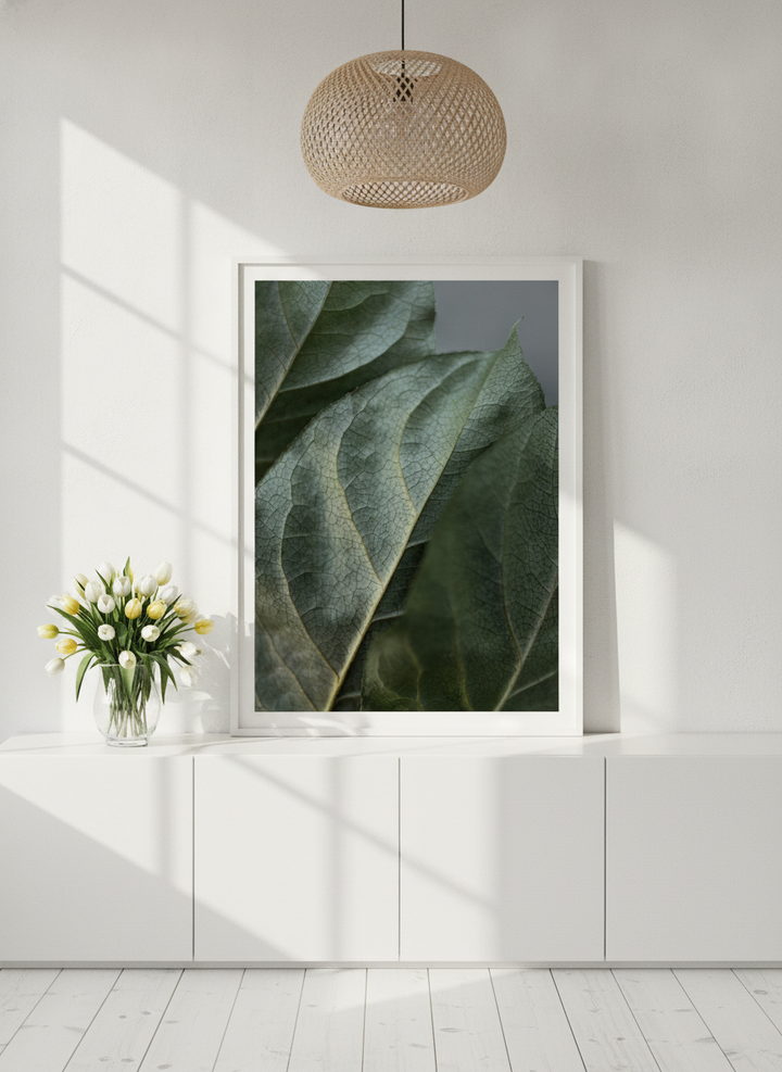 Modern wall art print standing on a sideboard in a bright Scandinavian bathroom