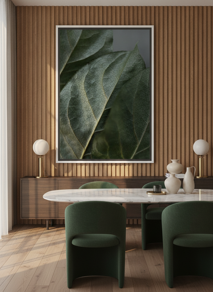 Oversized statement canvas wall art with a white surround styled on the wall in a luxe dining room