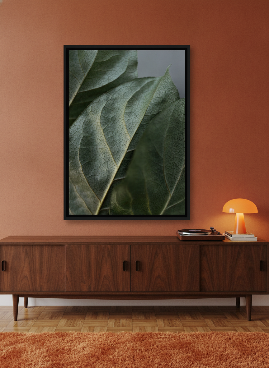 Canvas wall art with a black surround standing on a sideboard in a retro 70s home office