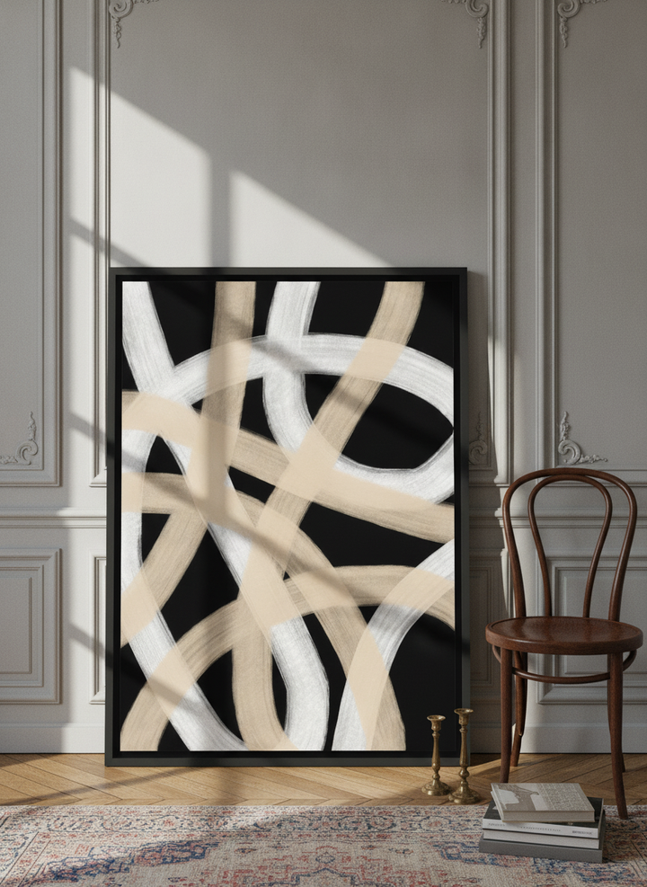 Canvas wall art with a black surround leaning against the wall in a Parisian bedroom