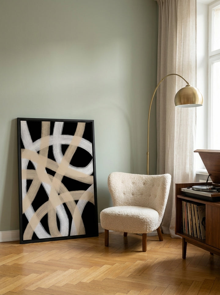 Oversized statement modern wall art print leaning against the wall in a mid-century dining room