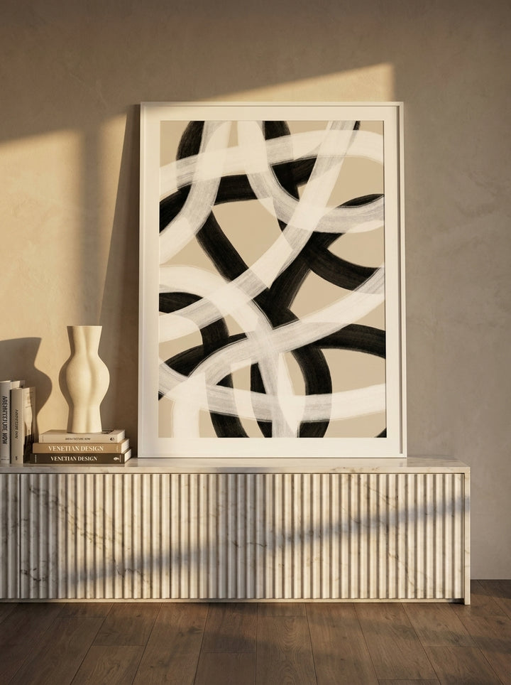 Modern wall art print standing on a sideboard in a luxe bedroom
