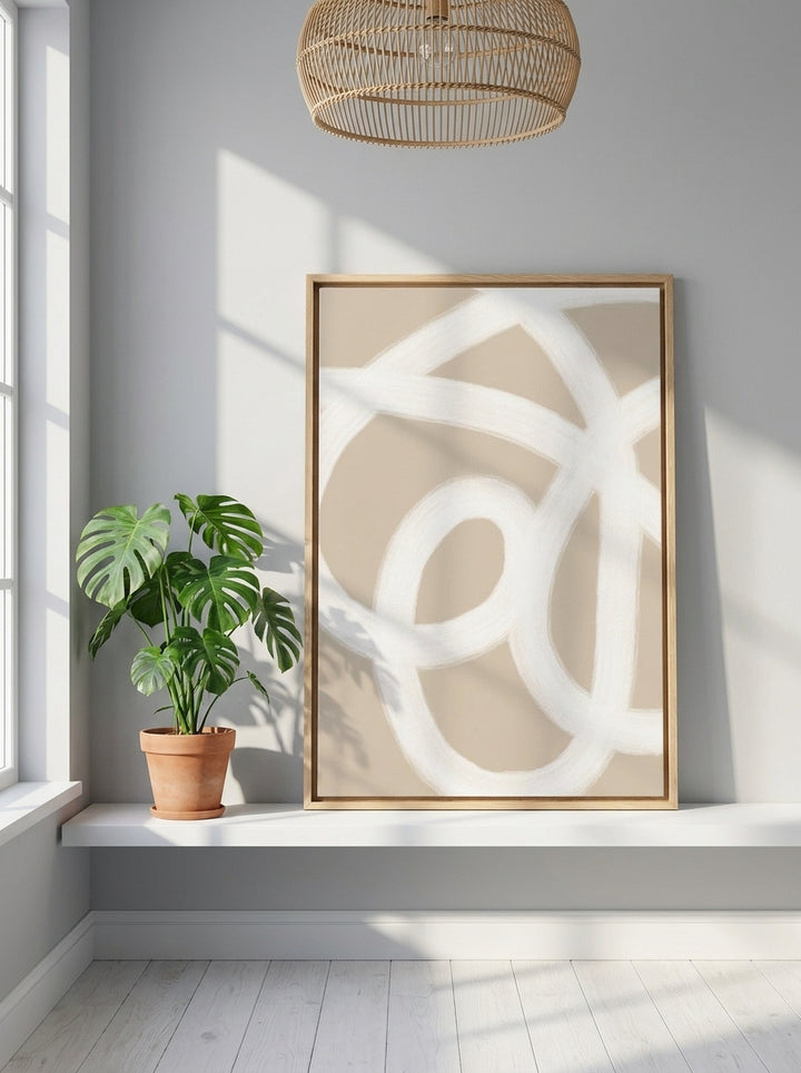Canvas wall art with a natural timber surround standing on a shelf in a bright Scandinavian bathroom
