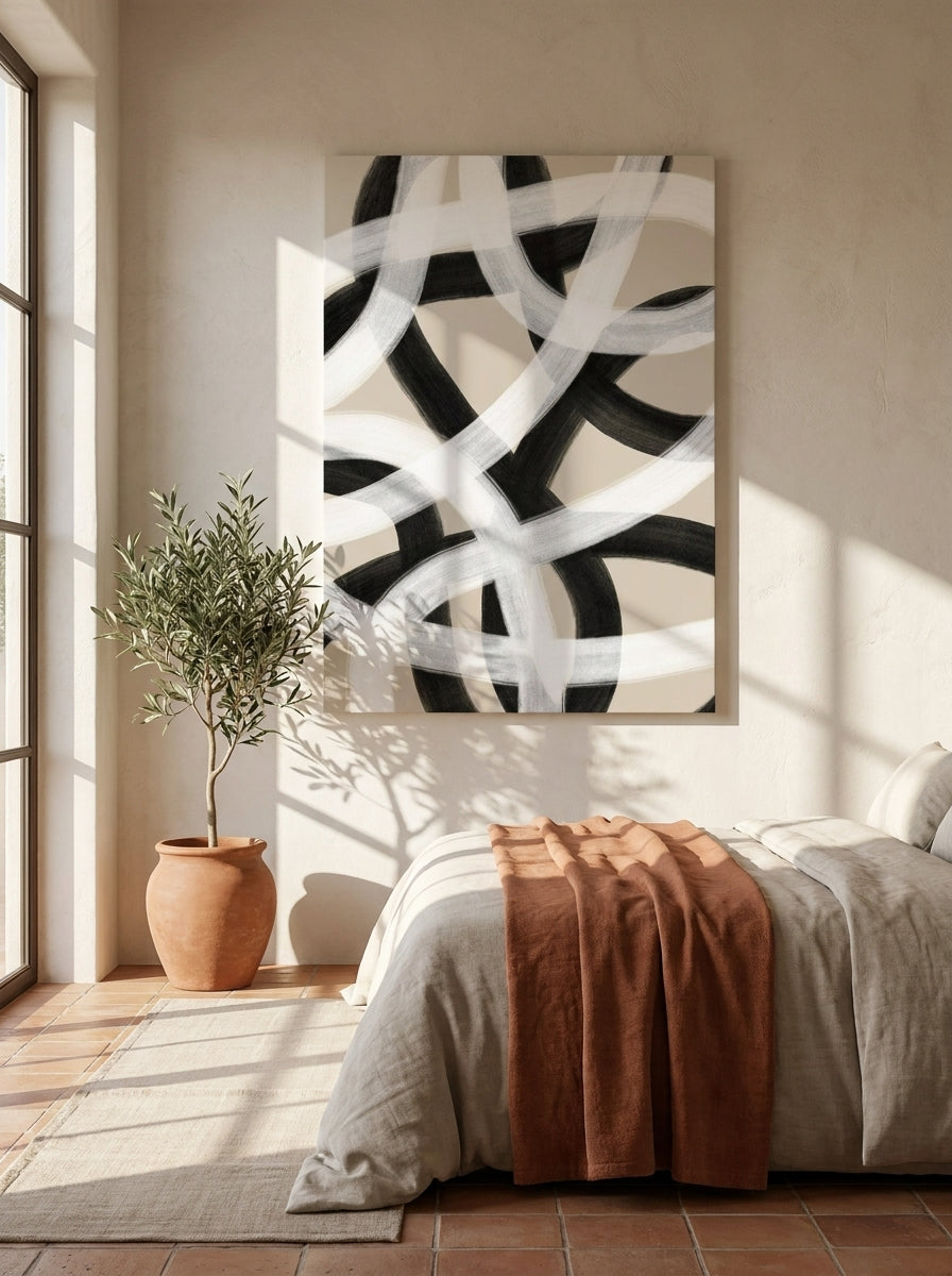 Stretched canvas wall art styled on the wall in a Mediterranean bedroom