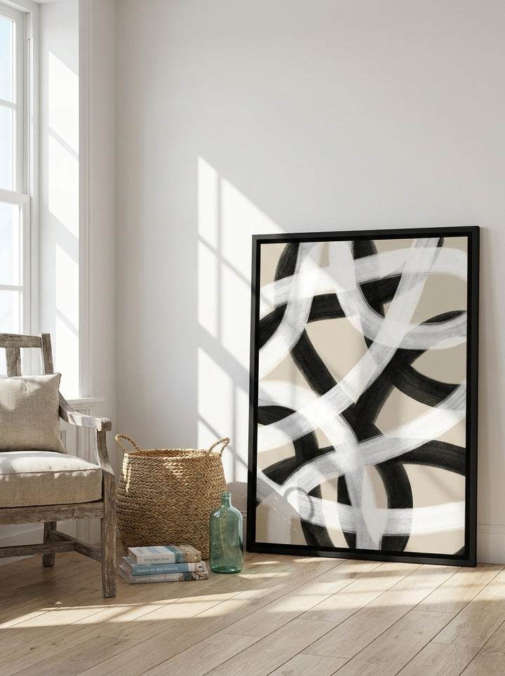 Canvas wall art with a black surround leaning against the wall in a coastal living room