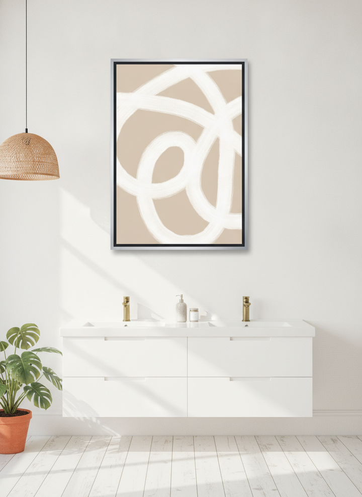 Canvas wall art with a silver leaf surround styled on the wall in a bright Scandinavian bathroom