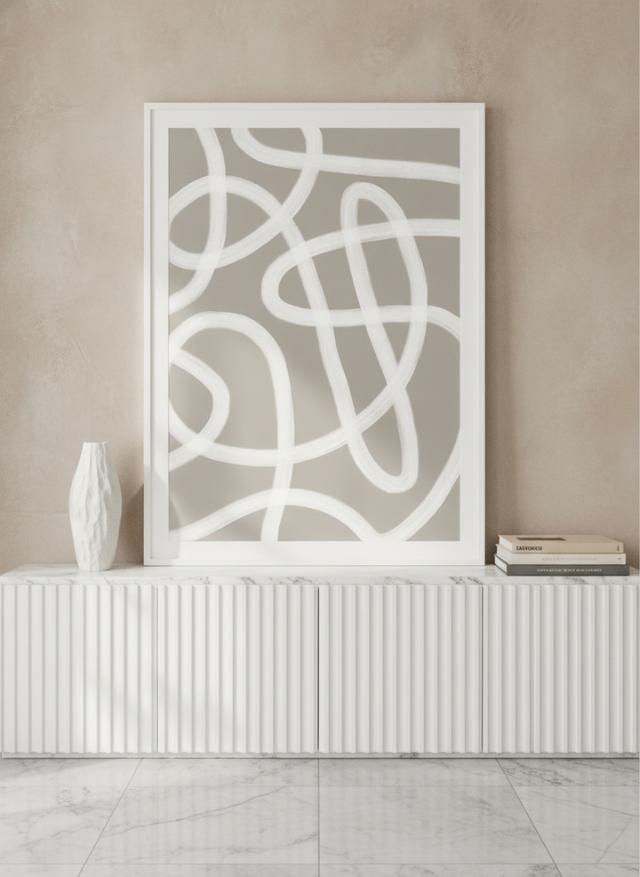 Modern wall art print standing on a sideboard in a luxe home office