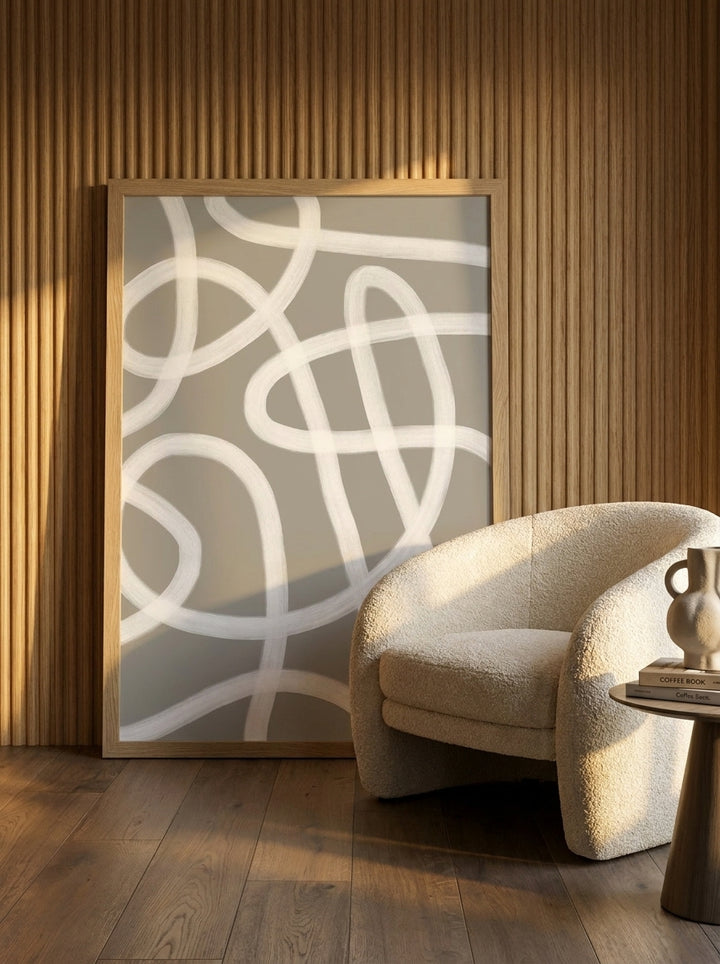 Oversized statement modern wall art print leaning against the wall in a luxe bedroom