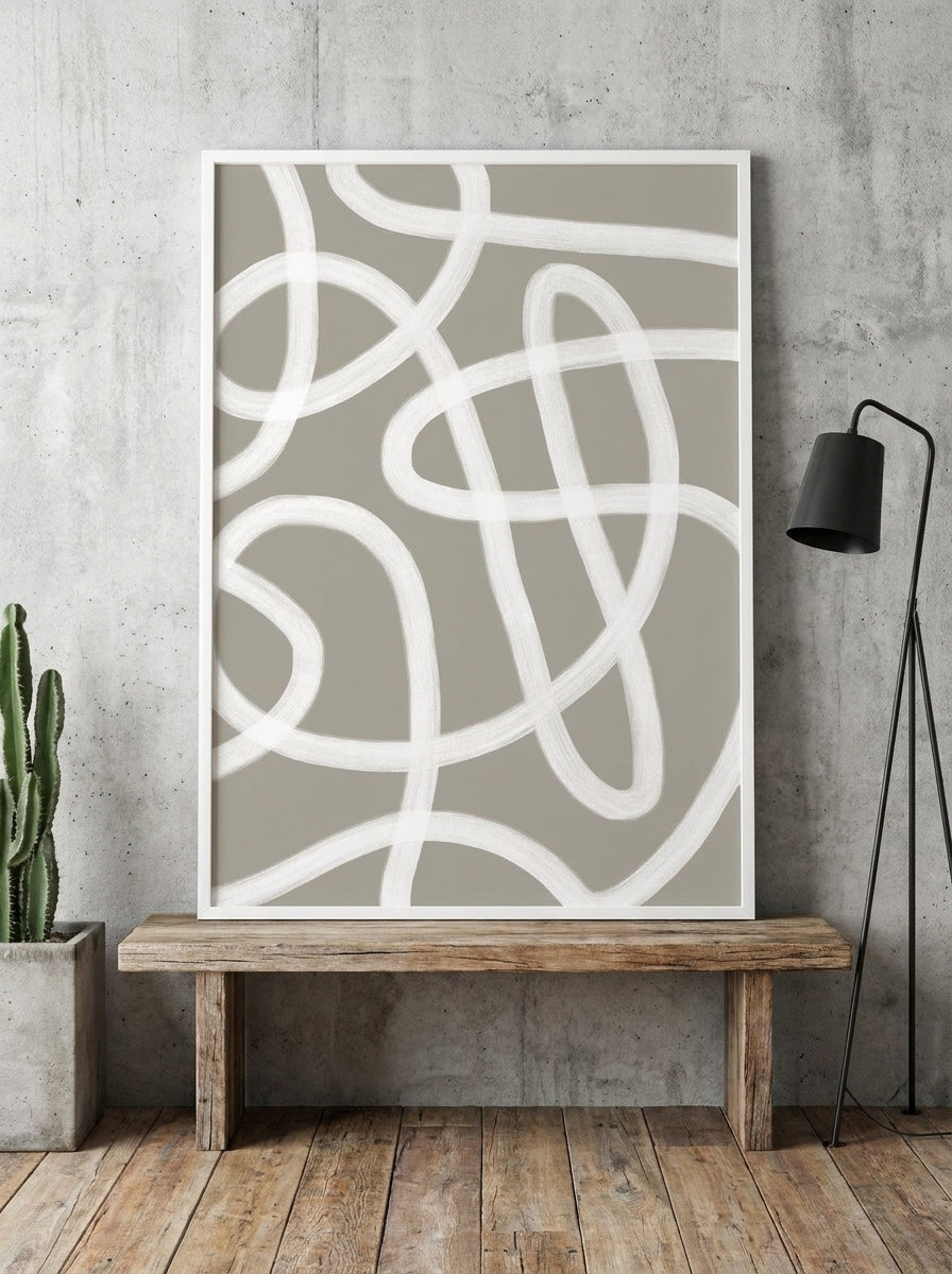 Modern wall art print standing on a bench in an industrial loft bedroom