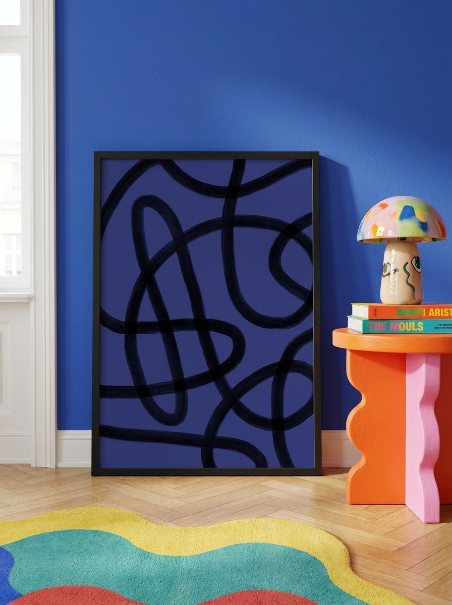 Modern wall art print leaning against the wall in a colourful eclectic living room