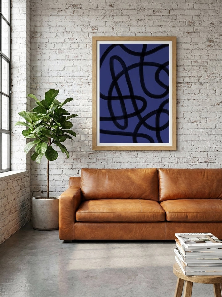Modern wall art print styled on the wall in an industrial loft living room