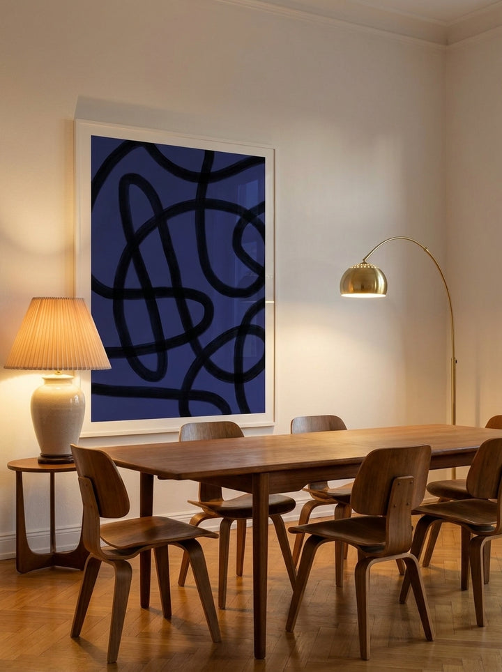 Oversized statement modern wall art print styled on the wall in a mid-century dining room