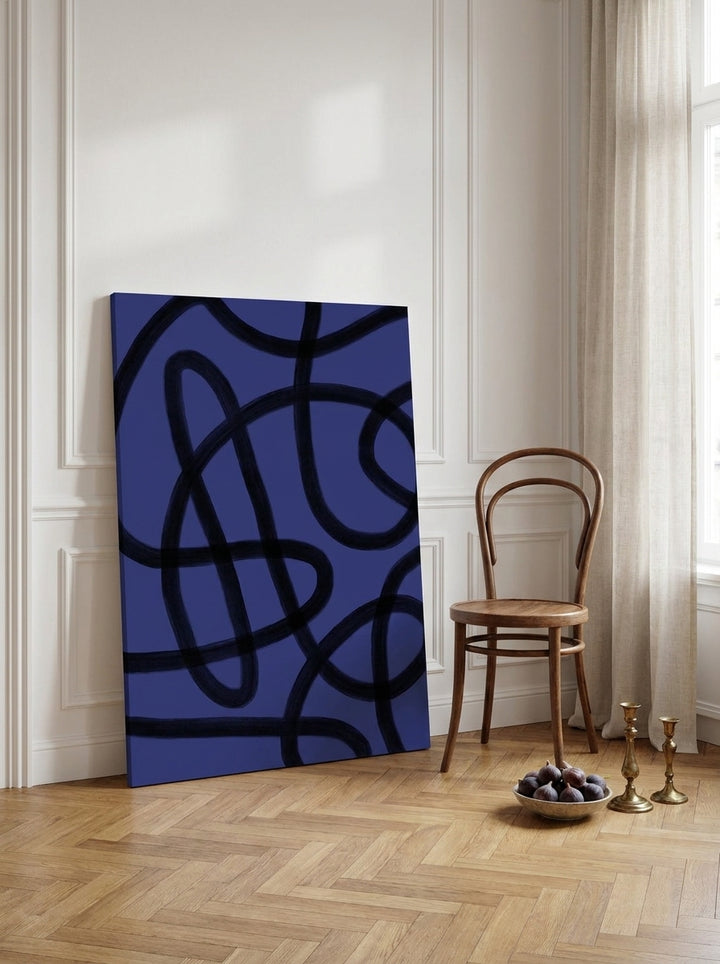 Stretched canvas wall art leaning against the wall in a Parisian living room