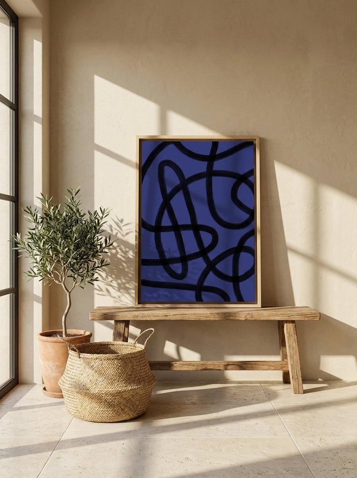 Canvas wall art with a natural timber surround standing on a bench in a Mediterranean home office