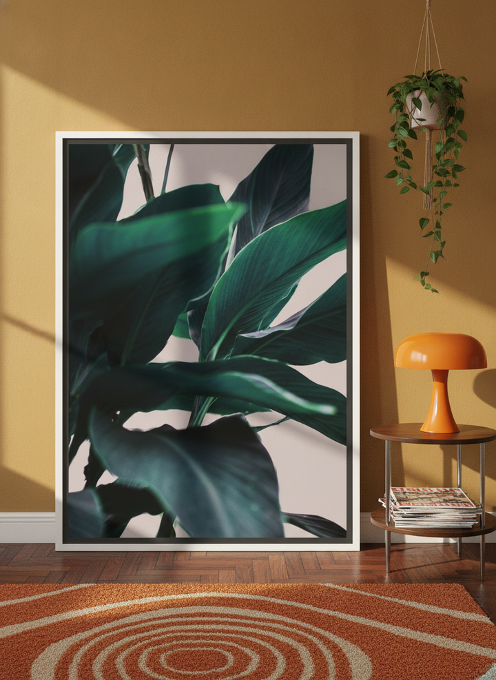 Oversized statement canvas wall art with a white surround leaning against the wall in a retro 70s dining room