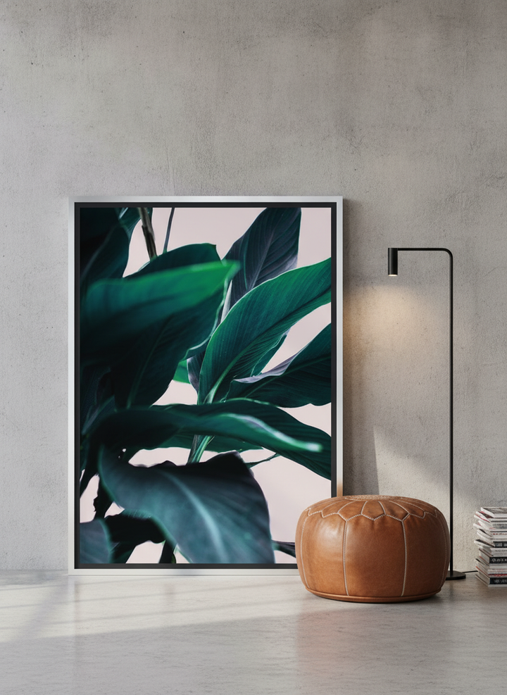 Canvas wall art with a silver leaf surround leaning against the wall in an industrial loft bedroom