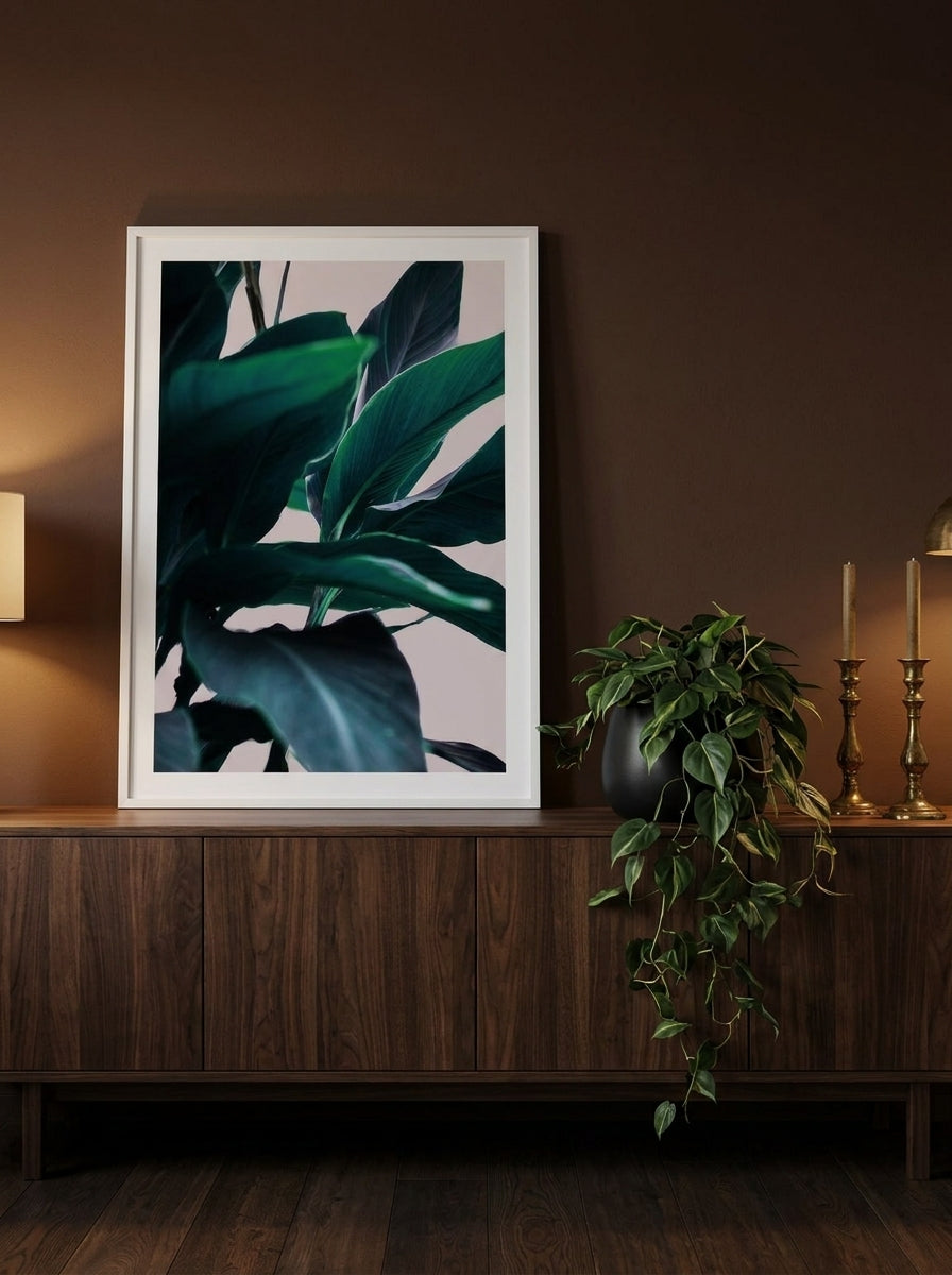 Modern wall art print standing on a sideboard in a moody home office