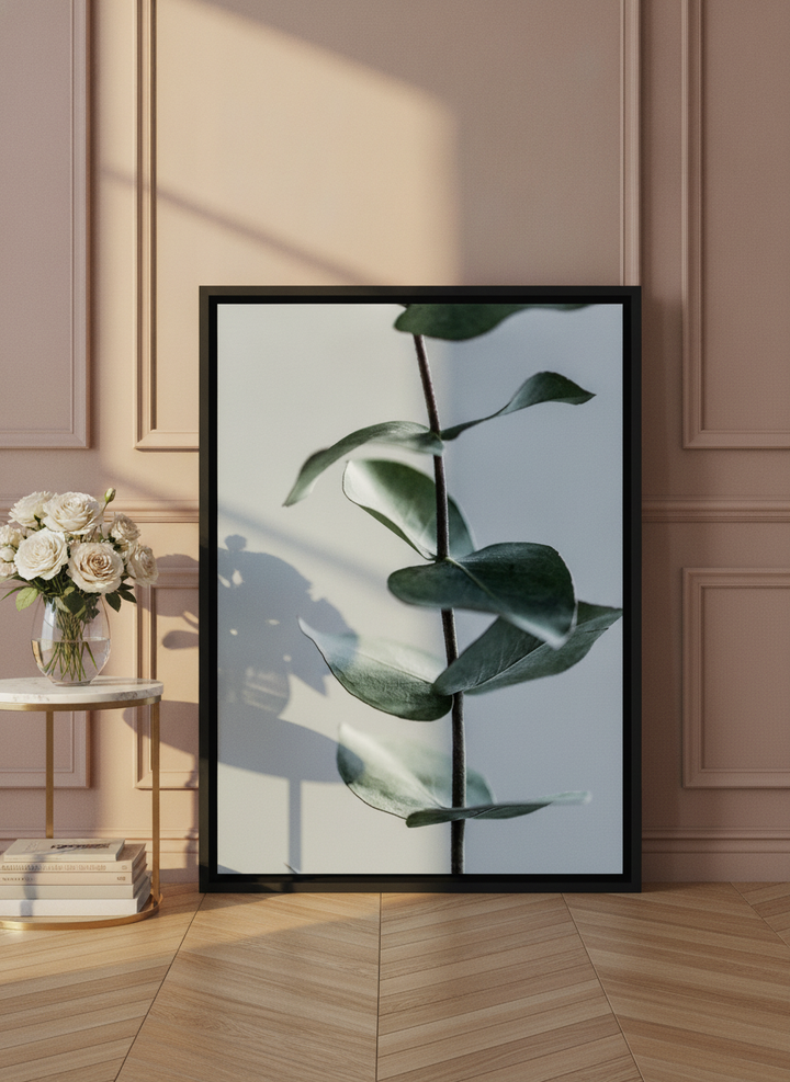 Canvas wall art with a black surround leaning against the wall in a Parisian bathroom