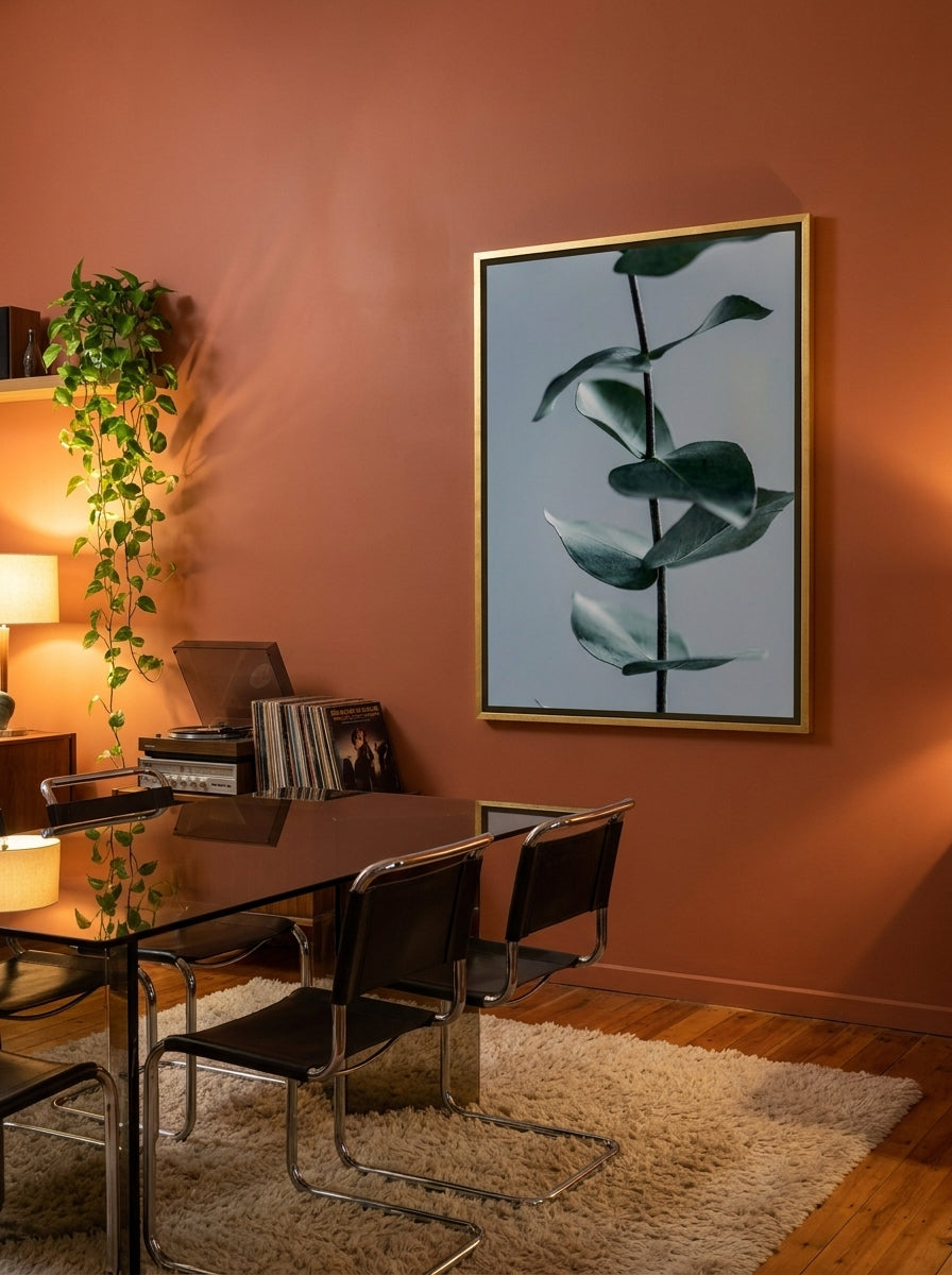 Oversized statement canvas wall art with a gold leaf surround styled on the wall in a retro 70s dining room