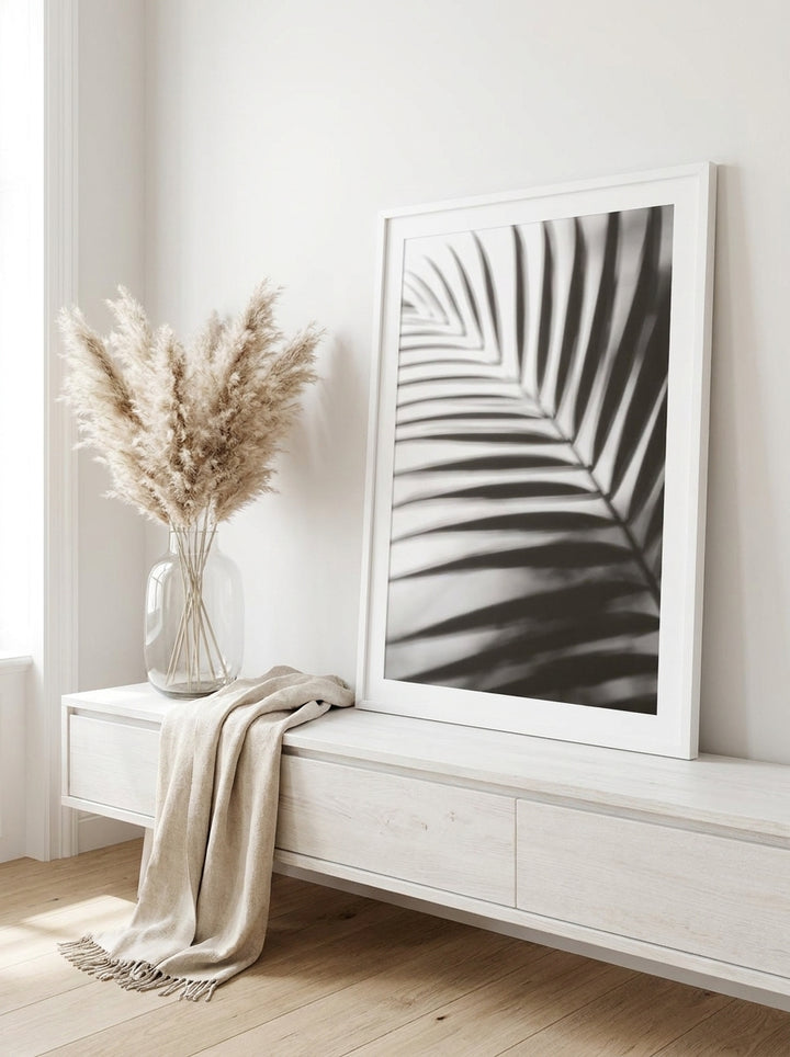Modern wall art print standing on a console in a coastal home office