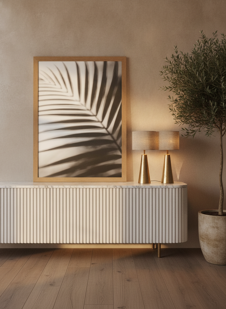 Modern wall art print standing on a sideboard in a luxe bathroom