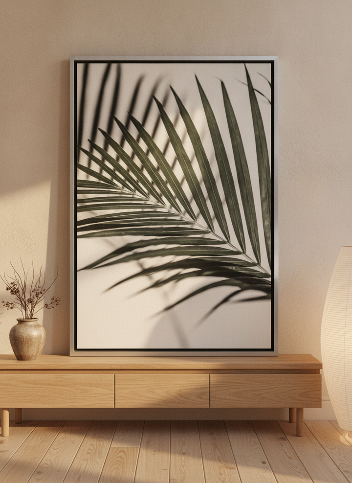 Canvas wall art with a silver leaf surround standing on a sideboard in a warm Japandi bedroom
