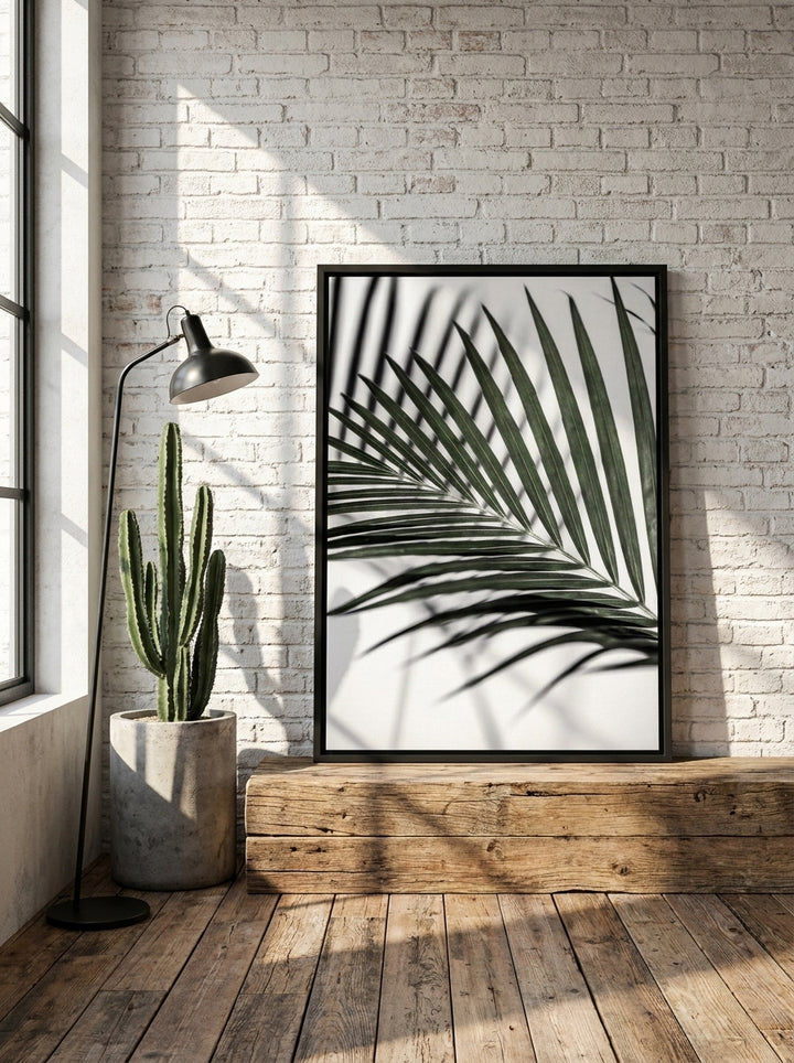 Canvas wall art with a black surround standing on a bench in an industrial loft home office