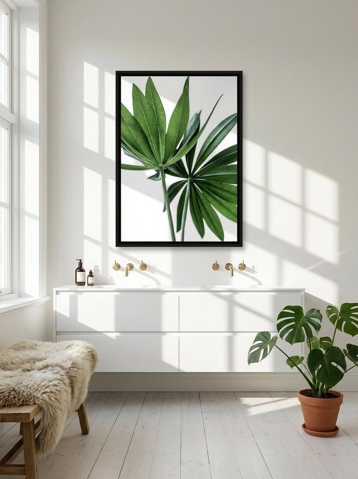 Canvas wall art with a black surround styled on the wall in a bright Scandinavian bathroom