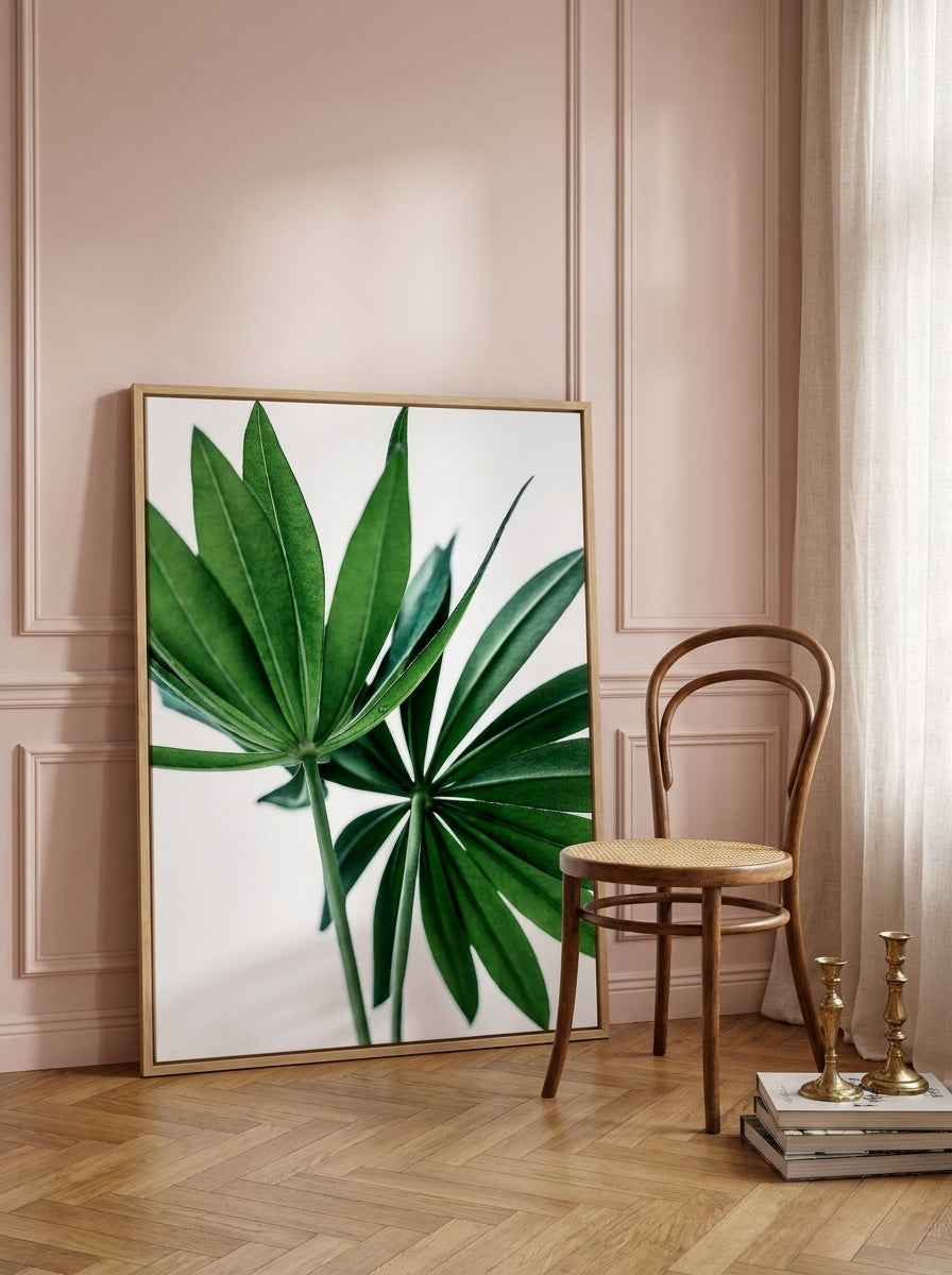 Oversized statement canvas wall art with a natural timber surround leaning against the wall in a Parisian bedroom