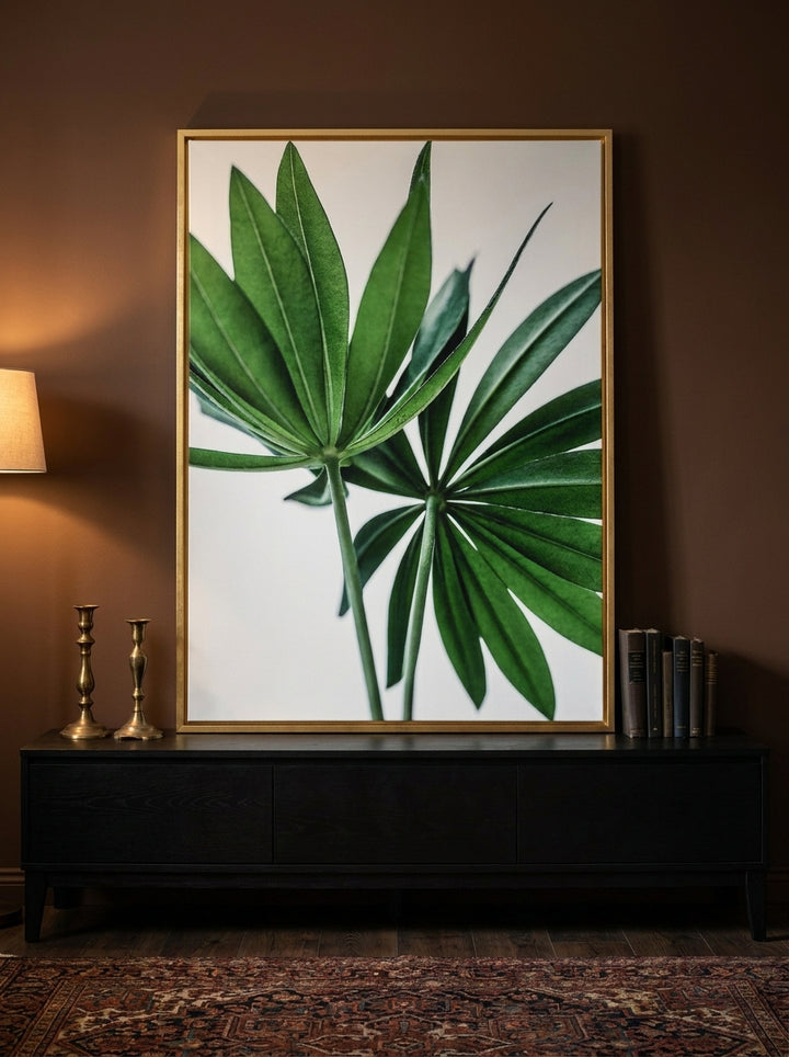 Canvas wall art with a gold leaf surround standing on a console in a moody home office