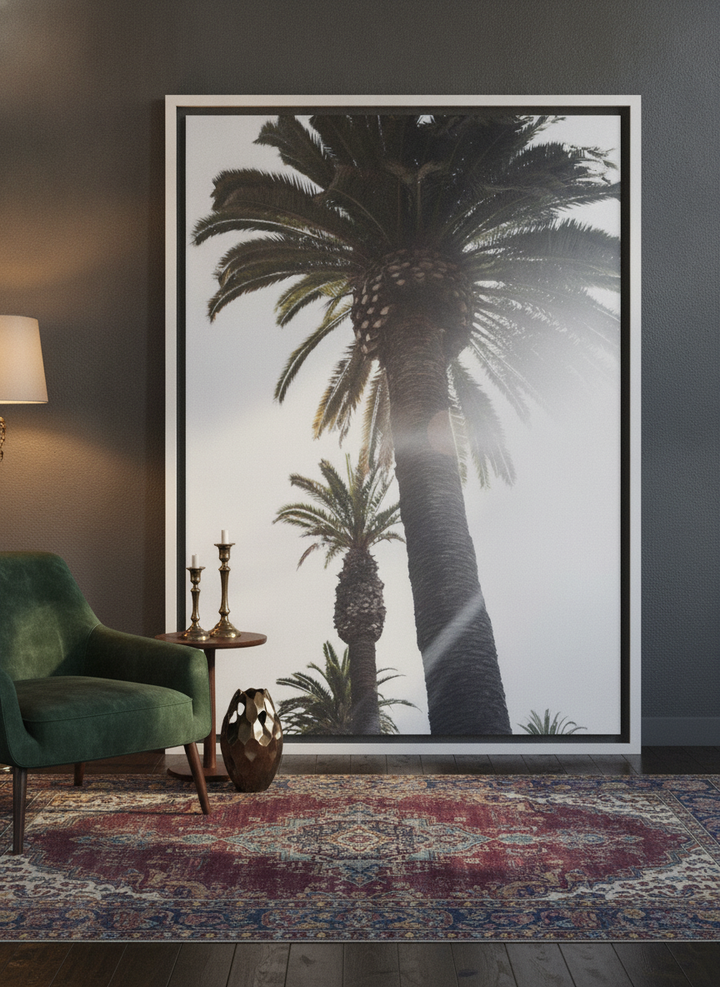 Oversized statement canvas wall art with a white surround leaning against the wall in a moody dining room