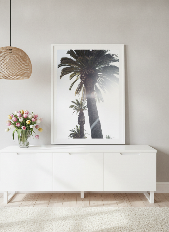 Modern wall art print standing on a sideboard in a bright Scandinavian bedroom