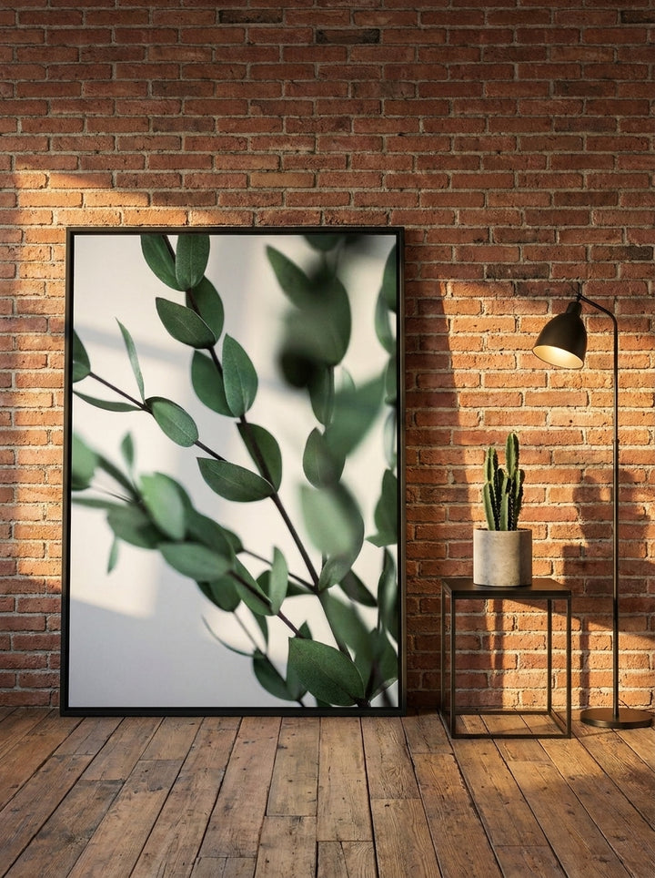 Oversized statement canvas wall art with a black surround leaning against the wall in an industrial loft living room