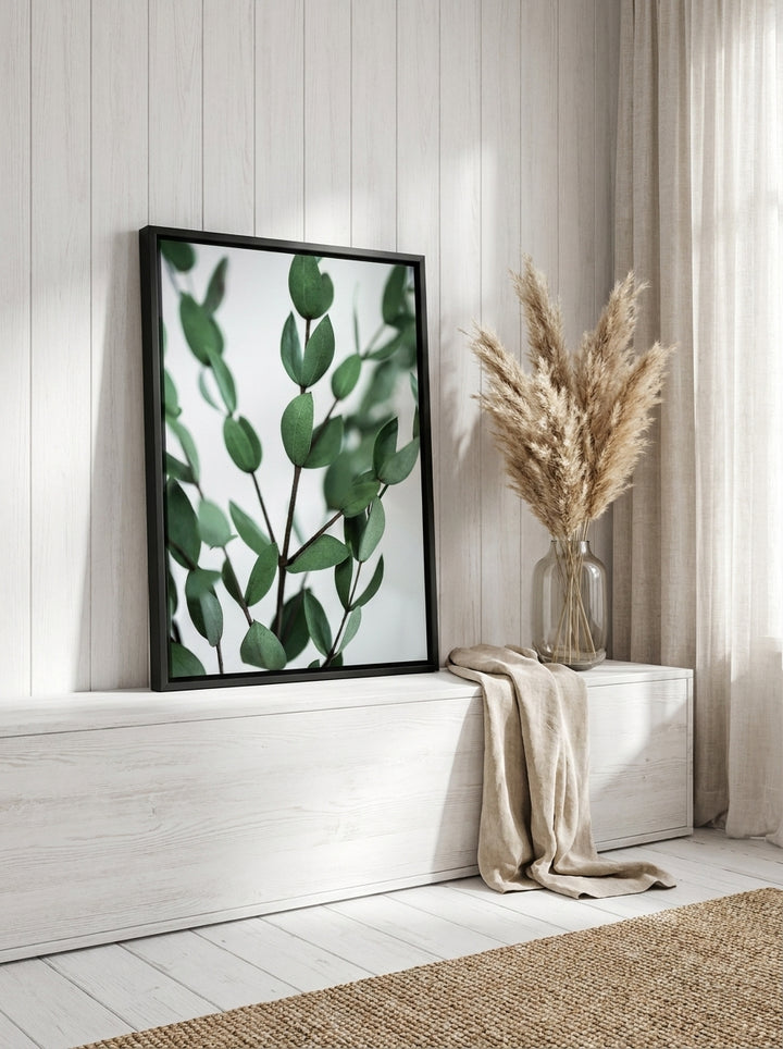 Canvas wall art with a black surround standing on a console in a coastal bathroom