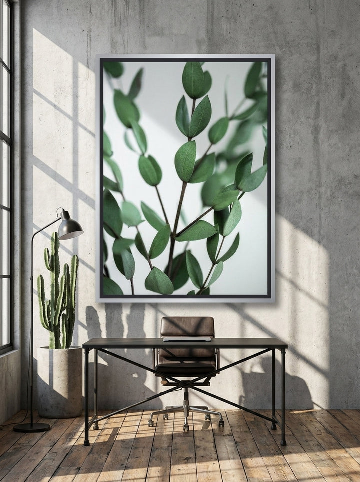 Canvas wall art with a silver leaf surround styled on the wall in an industrial loft home office
