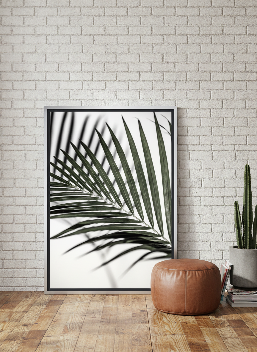 Canvas wall art with a silver leaf surround leaning against the wall in an industrial loft bedroom