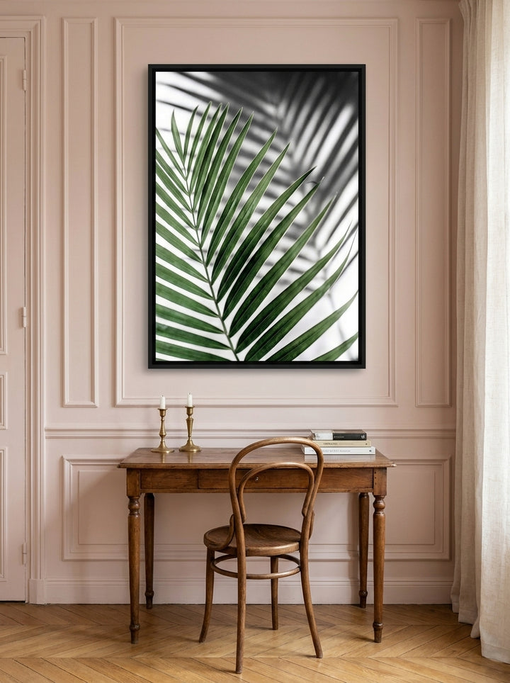 Canvas wall art with a black surround styled on the wall in a Parisian home office