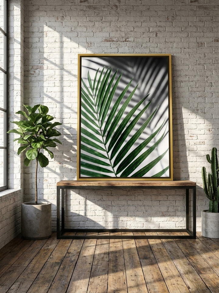 Canvas wall art with a gold leaf surround standing on a console in an industrial loft living room