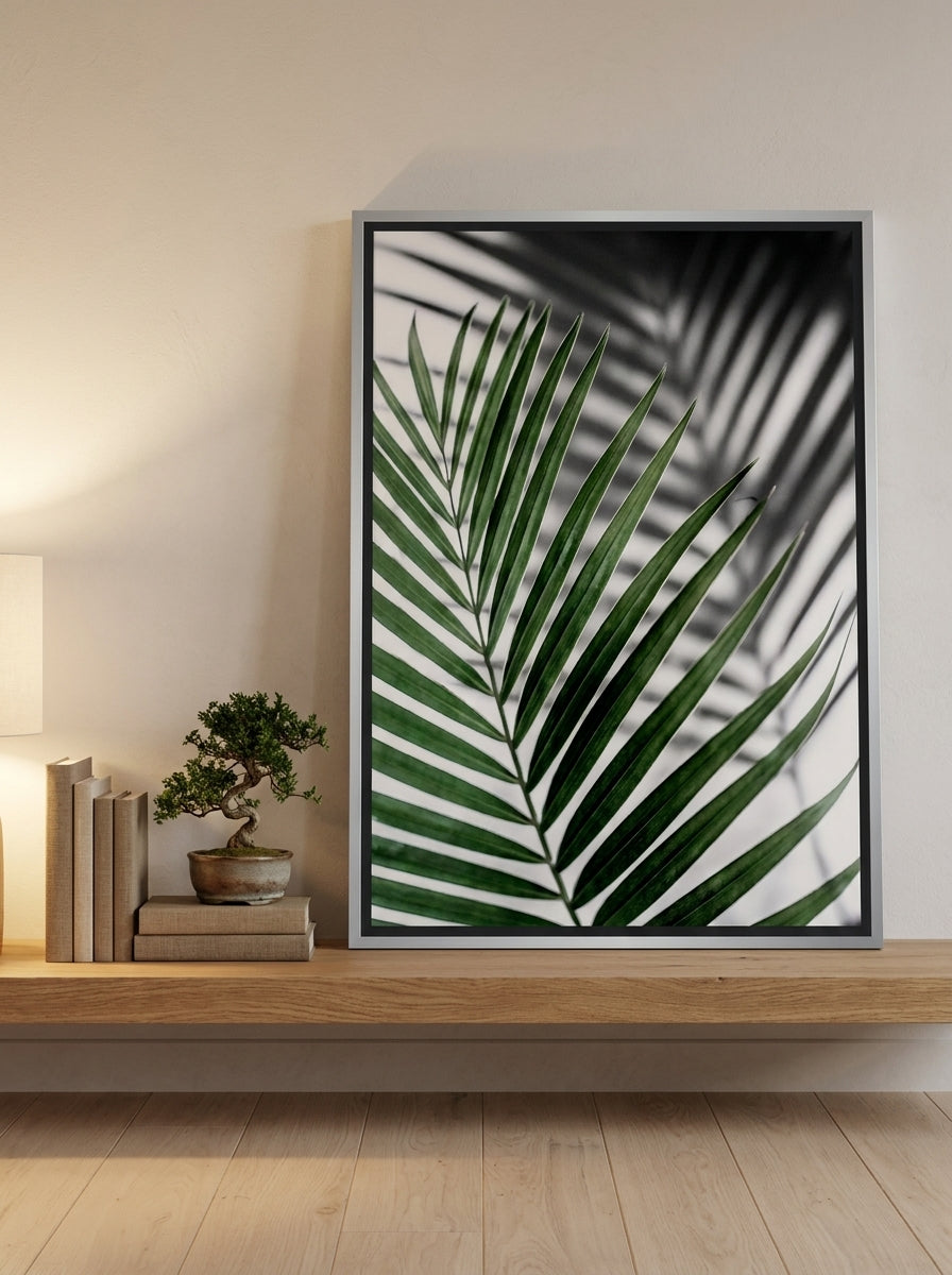 Canvas wall art with a silver leaf surround standing on a shelf in a warm Japandi bedroom