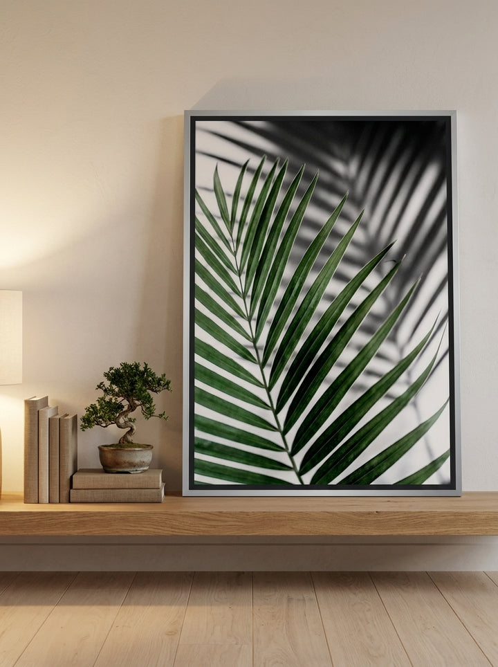 Canvas wall art with a silver leaf surround standing on a shelf in a warm Japandi bedroom
