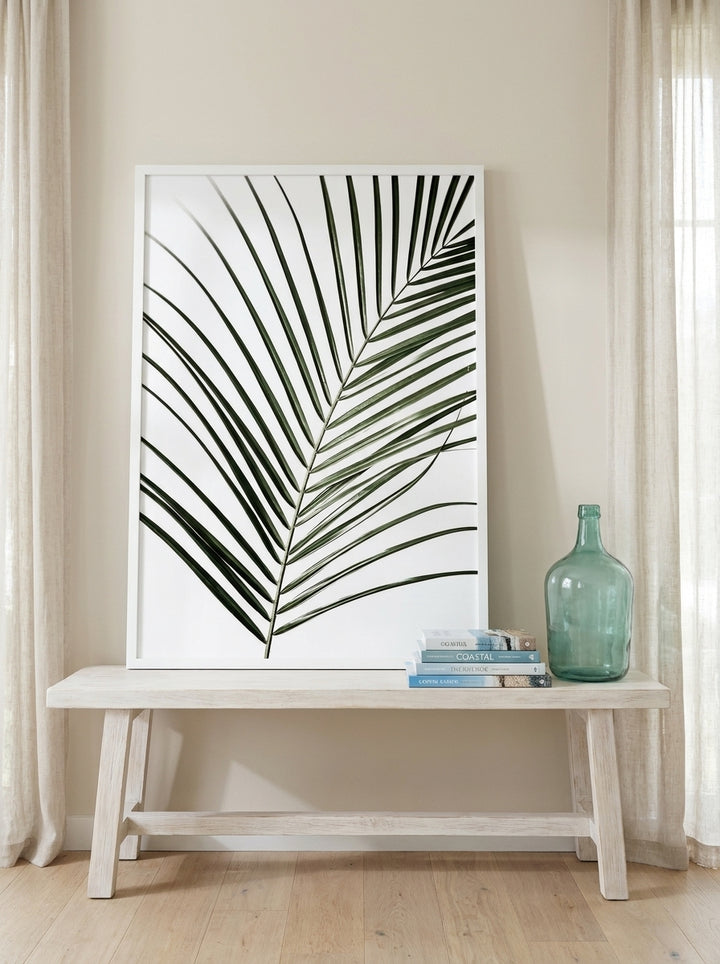 Modern wall art print standing on a console in a coastal bathroom