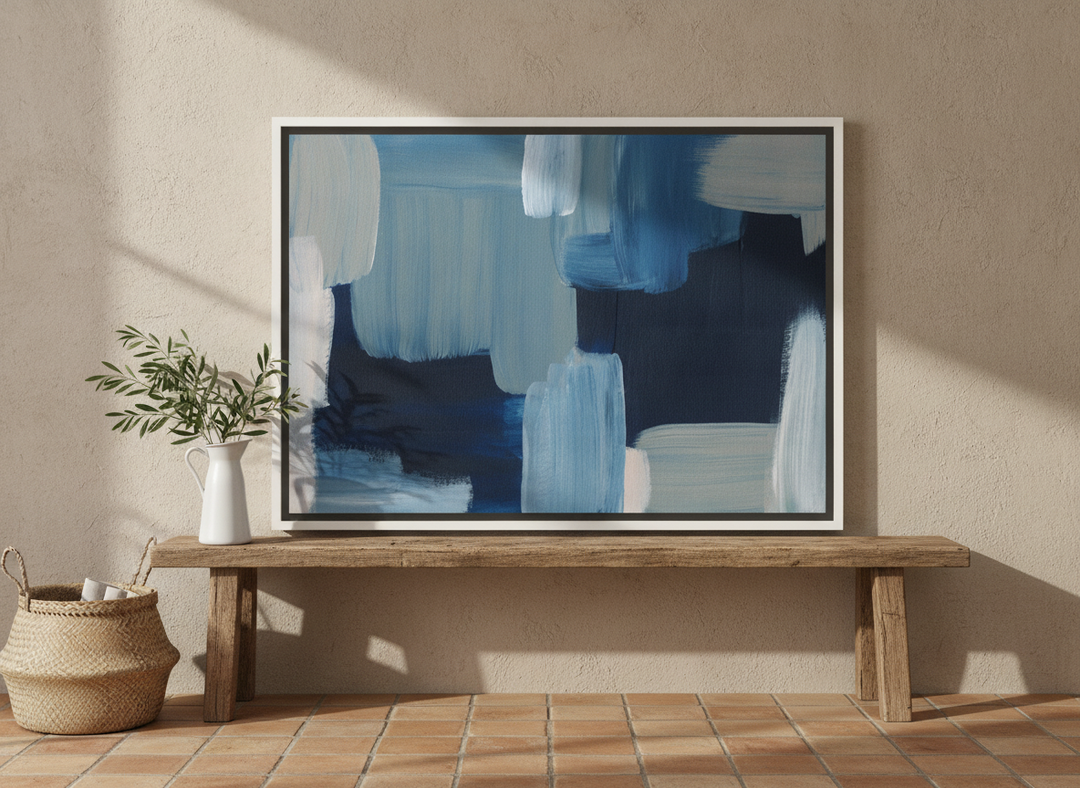 Canvas wall art with a white surround standing on a bench in a Mediterranean bathroom