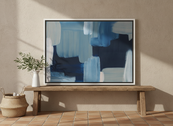Canvas wall art with a white surround standing on a bench in a Mediterranean bathroom