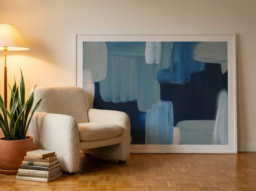 Oversized statement modern wall art print leaning against the wall in a mid-century living room