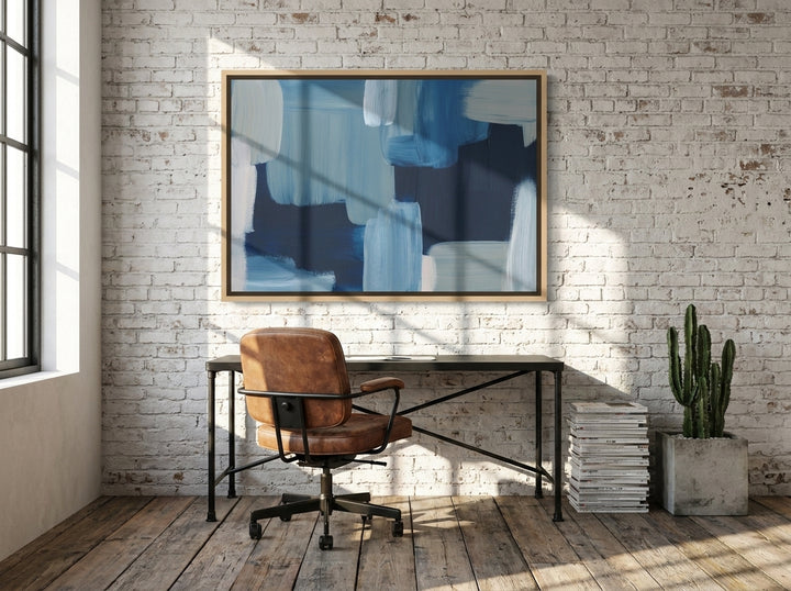 Canvas wall art with a natural timber surround styled on the wall in an industrial loft home office