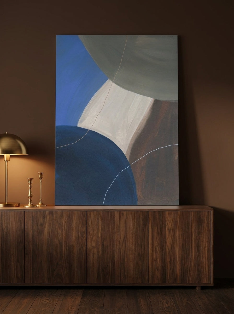 Stretched canvas wall art standing on a sideboard in a moody bedroom